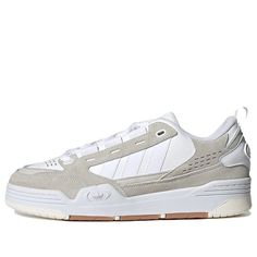 The adidas ADI2000 'Triple White' is a classic sneaker with a modern twist. It features an OG design from the 2000s, with a glossy leather trim to add a touch of shine. The upper is a mix of smooth leather and suede, while the rubber sole ensures a comfortable fit. Perfect for a casual stroll or a night out, this sneaker is sure to turn heads. Inspired by the iconic ADI2000 series, this timeless design is sure to be a hit. With its sleek silhouette and timeless design, the adidas ADI2000 'Triple Modern Adidas Skate Shoes For Streetwear, Adidas Skate Shoes With Abzorb Midsole For Streetwear, Adidas Skate Shoes With Abzorb Midsole And White Sole, Adidas Adi2000, Sneakers Adidas, The 2000s, Classic Sneakers, Stylish Sneakers, Adidas Men