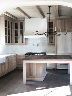 a large kitchen with wooden cabinets and an island