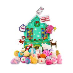 an assortment of stuffed animals and toys in front of a christmas themed house with the words,