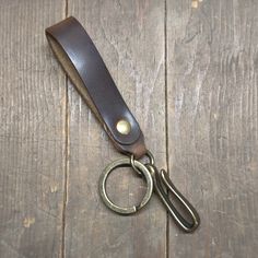 a leather keychain with a metal ring on it