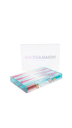 the backgammon box contains three different colored lipsticks and one is in it's packaging