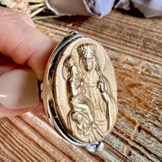 This is a beautiful and detailed statement ring depicting Saint Anne with a young Mary on her lap.  The image is hand replicated in my studio from an antique French religious medal and recreated in bronze clay.  This high relief image is set in a rustic asymmetrical ring base.  This design has been a favorite of my customers and I have decided to offer it online for others to enjoy.  It is a large ring design, and truly makes a beautiful statement of faith.  Please see all of the pics with the ring on my hand to get an idea of it's size.  It's also adjustable.  Request your size when ordering and I will form it on a mandrel.  The ring base is antique silver-plated brass, nickel free & lead free.  The hand-set kiln fired design is solid (not plated) bronze in a beautiful light gold color. Antique Hand Cast Jewelry For Wedding, Antique Hand Cast Wedding Jewelry, Heirloom Hand Cast Jewelry Gift, Vintage Oval Hand-cast Jewelry, Asymmetrical Ring, Saint Anne, Light Gold Color, Fire Designs, St Anne