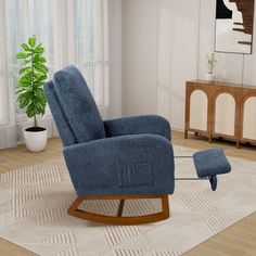 a blue recliner chair and ottoman in a living room with a potted plant