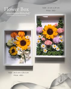 two boxes with flowers in them on display