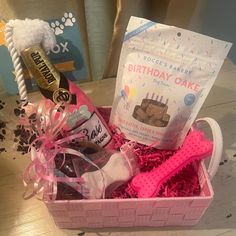 a birthday cake gift basket with pink ribbon