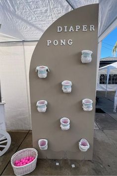 there are many cups on the sign and some balls in baskets next to each other