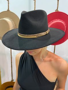 Ok, we're freaking out! The Joshua Hat is our newest favvvvv. It's everything a girl could dream of in a hat. Incredible quality, a pointed rancher crown, super structured, and an elastic inner-band. Black is always in style and you'll be in love. The elegant crown is stiffened and shaped into a clean and ridged design, finished with a braided trim. It's timeless, will last forever, and adds the perfect touch of coolness to any look. -Rancher style hat with some edge -Incredible quality -Brim is Fall Costume Hats With Curved Brim, Black Wide Brim Felt Hat For Festival, Wide Brim Black Hat For Ranch, Black Fedora With Curved Brim For Rodeo, Adjustable Fedora Costume Hats For Fall, Black Wide Brim Hat For Ranch, Black Curved Brim Hat For Country Events, Black Brimmed Costume Hat For Country Events, Black Flat Crown Hat For Western-themed Events