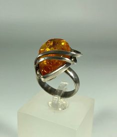 Discover the timeless elegance of our Spectacular Orange Amber Ring, expertly crafted for ladies in stunning 925 melting silver. This exquisite piece features natural Baltic Sea amber, renowned for its unique beauty and healing properties. Perfect for any occasion, this amber ring will add a touch of sophistication to your jewelry collection. Product Details: Material: 925 Sterling Silver Stone: Natural Baltic Sea Amber Color: Spectacular Orange Design: Melting Silver Style Ring Size: 8 Us size Modernist Hallmarked Wedding Rings, Modern Amber Jewelry For Anniversary, Modernist Oval Rings For Formal Events, Modernist Oval Rings For Formal Occasions, Modernist Oval Jewelry For Formal Occasions, Modern Amber Rings For Anniversary, Modernist Ring With Polished Finish For Anniversary, Modernist Jewelry With Polished Finish For Promise Ring, Modernist Rings With Polished Finish For Anniversary