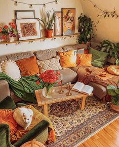 a living room filled with lots of furniture and plants on top of the couches