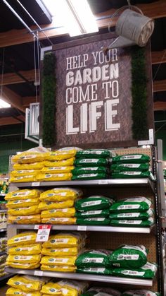 there is a sign that says help you garden come to life on the shelf in the store