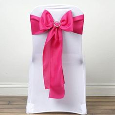 a white chair with pink sashes on it