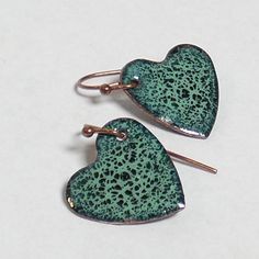 "Green on green crackle enamel hearts - minty grass green beauties.  .5\" by .5\". SOLID TITANIUM EARWIRES ARE AVAILABLE FREE UPON REQUEST - please message me. My enameled items are made with love using glass powder enamels on copper, kiln-fired to about 1500oF, and require many layers and firings. Backs are finished with enamel, and pieces are set with copper findings. I have been in the glassworking and jewelry-making trades since 1994 and have a deep love and respect for glass of any kind." Green Jewelry With Black Enamel For Gift, Green Jewelry With Black Enamel As A Gift, Green Teardrop Enamel Jewelry, Green Enamel Jewelry With Black Enamel, Green Heart-shaped Hypoallergenic Jewelry, Hypoallergenic Green Enamel Jewelry, Hypoallergenic Green Heart Jewelry, Vintage Green Patina Earrings, Nickel-free Green Heart Earrings