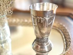 a silver cup sitting on top of a metal tray