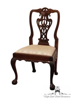 an ornate wooden chair with white fabric seat padding and back cushion, on a white background