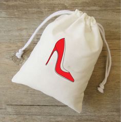 a drawstring bag with a red high heel shoe on it