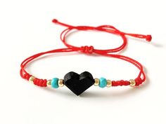 "Red String Azabache Bracelet Beautiful and dainty bracelet with a protection amulet stone (azabache) ideal to keep yourself protected from evil eye, envy and negative vibes or energies. It's made with red cotton cord, turquoise beads and gold filled balls. MATERIALS AND SIZE: Adjustable 5.5\" up to 8.5\" Jet stone/azabache Heart dimension: 1.1cm If you have questions about the product, feel free to reach me out. Don't forget to check out my other items in the store: Https://www.etsy.com/shop/ny Handmade Black Friendship Bracelets For Valentine's Day, Black Beaded Bracelets With Heart Beads, Black Beaded Bracelets With Heart Beads As Gift, Black Beaded Bracelets With Heart Beads For Gifts, Handmade Black Bracelets For Valentine's Day, Handmade Black Bracelet For Valentine's Day, Black Bracelet With Heart Charm, Valentine's Day Black Heart Charm Bracelet, Black Heart Bracelets With Heart Charm