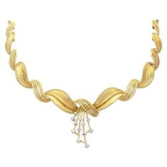 A stunning vintage Belgian 1950s 0.54 carat diamond and 18 karat yellow gold necklace; part of our diverse vintage jewelry and estate jewelry collections. This stunning, fine and impressive vintage diamond necklace has been crafted in 18k yellow gold with 18k white gold settings. The articulated setting is composed of curvilinear feather shaped links, graduated in size. The centre of the shaped setting is ornamented with a multi-stranded drop setting, embellished with twelve individually 18k whi Womens Gold Necklace, Vintage Diamond Necklace, Pearl Drop Necklace, Yellow Gold Necklace, Gold Necklace Women, Gold Jewelry Fashion, Drop Necklace, Vintage Diamond, Vintage Jewellery