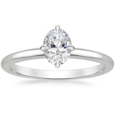 a white gold engagement ring with an oval cut diamond in the center, on a plain band