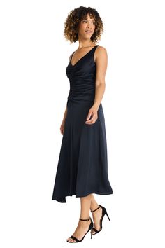 Meet Carmie, a stunning midi dress crafted from luxurious heavy charmeuse. The sleek silhouette features elegant ruching at the bodice and a flowing asymmetrical hemline. Perfect for cocktail parties evening galas or upscale dinners. Pair with statement earrings and strappy heels for a head-turning look. Pre-draped Party Dress With Ruched Sides, Sleek Bias Cut Dresses For Formal Events, Pre-draped Bias Cut Evening Dress For Cocktail, Fitted Cocktail Evening Dress With Ruched Back, Pre-draped Evening Dress With Ruched Asymmetrical Neckline, Ruched Asymmetrical Evening Dress, Evening Dress With Ruched Detail And Asymmetrical Neckline, Ruched Evening Dress With Asymmetrical Neckline, Fitted Bodice Dress With Ruched Back For Gala