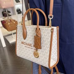 Michael Kors Mirella Small Shopper Top Zip Crossbody Bag Vanilla Logo Mk Gold-Tone Hardware Dimensions: 9.25”W X 7.75”H X 3.75”D Approx Handle Drop: 3.25” Approx Adjustable Strap: 20.25”-23.75” Approx Interior Details: Back Zip Pocket, Front Slip Pocket Lining: 100% Polyester Vanilla Logo, Logo Mk, Bags Wishlist, Large Crossbody Purse, Michael Kors Crossbody Bag, Girly Bags, Small Crossbody Purse, Fancy Bags, Leather Handbags Crossbody