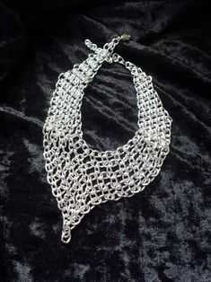 "This aluminum chainmail necklace is quite a chameleon. The length is adjustable so you can change this piece from an edgy choker to an elegant short necklace by re-positioning the clasp. The first 2 photos illustrate the transformation from a 14\" long choker (photo 1) to a 17\" long necklace (photo 2). You'll have to select your color and the necklace length (measured along the top of the necklace, including the clasp). The extension chain will be 3\". If you want it longer or shorter leave me Unique Metal Choker With Adjustable Chain, Metal Chainmail Necklace For Party, Party Chainmail Metal Necklace, Silver Bib Necklace Choker For Evening, Evening Metal Choker Chain Necklace, Silver Metal Choker For Evening, Metallic Party Necklaces, Unique Metal Chain Choker, Metal Chain Choker For Evening