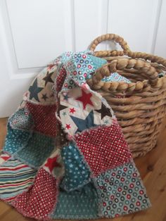 a basket sitting on top of a wooden floor next to a door covered in fabric