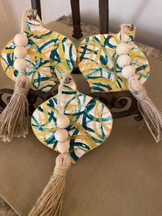 three decorative plates with tassels and beads