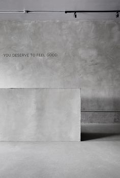 a man riding a skateboard up the side of a ramp in a cement building