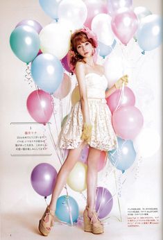 a woman standing in front of balloons with her hands on her hips and legs crossed