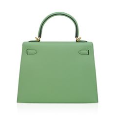 Guaranteed authentic Hermes Kelly Sellier 25 bag featured in fresh Vert Criquet. Stunning Hermes light green that is absolutely neutral. Luxurious with gold hardware.Epsom leather accentuates colours beautifully as it saturates to perfection. Comes with signature Hermes box, raincoat, shoulder strap, sleepers, lock, keys and clochette. NEW or NEVER WORN.The Hermes Kelly Sellier 25 cm bag price retains its value due to the rarity and high demand. As a purveyor of exceptional and unique Hermes lux Hermes Crocodile Bag, Kelly 25 Sellier, Hermes Kelly Sellier, Hermes Kelly 25, Kelly 25, Kelly Sellier, Famous Photos, Crocodile Bags, Hermes Box