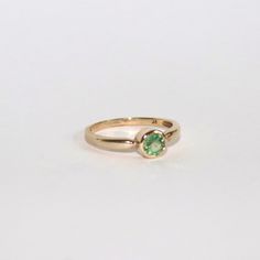 This ring has undergone a transformation. It started off a solid 9ct gold ring but it was set with a white CZ (CZ's are worth no more than a few pence each) I feel as though 9ct gold deserves to be set with something truly special. I sourced this gorgeous 4.5mm sage green sapphire to be encased in this metal. This piece really has a piece of my heart and I can't wait to see it be worn by someone who loves it just as much. It is a size N and weighs 1.72g and it is fully hallmarked. Formal Yellow Gold Tsavorite Rings, Classic 14k Gold Birthstone Ring With Bezel Setting, 14k Gold Emerald Solitaire Ring With Round Cut, 14k Gold Solitaire Emerald Ring With Round Cut, Classic Round Birthstone Ring With Bezel Setting, 14k Gold Green Diamond Ring With Round Band, 14k Gold Rings With Brilliant Cut May Birthstone, 14k Gold Brilliant Cut Ring For May Birthstone, Green 14k Gold Diamond Ring With Round Band