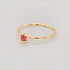 Celebrate your July birthday with the Large July Birthstone Ring, featuring a vibrant 4mm bold red CZ stone. This striking stone represents love and courage, making it a powerful addition to any jewelry collection. The ring is crafted with a 14K yellow gold-filled band, offering both elegance and durability. Whether worn alone or stacked with other personalized rings, this piece is a perfect way to showcase your unique style. Features 4mm CZ stone with a vibrant bold red hue. 14K gold-filled ban Red 14k Gold Stackable Birthstone Rings, Red Birthstone Stackable Rings, Red Birthstone Ring With Round Stone For Gift, Red Birthstone Ring With Round Band, Gold Ruby Birthstone Ring With Round Band, Red Birthstone Stackable Rings As Gift, Gold Stackable Ruby Birthstone Ring, Minimalist Red Birthstone Ring In 14k Gold, Red 14k Gold Stackable Rings As Gift