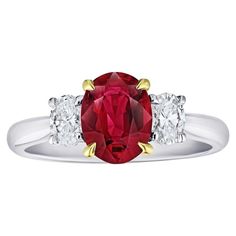 a red and white ring with three diamonds