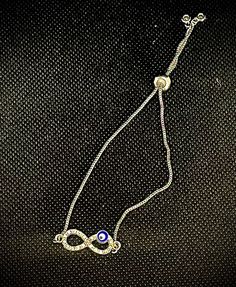 Silver plated chain with evil eye infinity, charm bracelet. Trendy Infinity Jewelry Gift, Trendy Infinity Jewelry For Gift, Elegant Infinity Charms Jewelry, Elegant Party Jewelry With Evil Eye Detail, Elegant Infinity-style Jewelry With Charms, Elegant Evil Eye Jewelry For Party, Evil Eye Metal Jewelry For Parties, Metal Evil Eye Jewelry For Parties, Silver Infinity Metal Bracelets