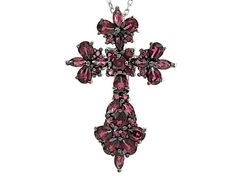 .42ctw round, .90ctw marquise and 2.40ctw pear shape raspberry color rhodolite garnet rhodium over sterling silver cross pendant with 18" Singapore chain. Measures approximately .31"L x .88"W. 2.5mm bail. Lobster claw clasp with a 2" extender. Finished back. Black rhodium. Silver Multi-stone Pear-shaped Jewelry, Silver Pear-shaped Multi-stone Jewelry, Pear-shaped Multi-stone Silver Jewelry, Silver Marquise Jewelry With Gemstone Accents, Silver Jewelry With Marquise Gemstone Accents, Silver Pear-shaped Gemstone Jewelry, Silver Jewelry With Gemstone Accents In Marquise Shape, Raspberry Color, Sterling Silver Cross Pendant