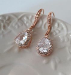 Crystal Rhinestone Bridal Earrings Rose Gold, Wedding Jewelry, Sparkling Cubic Zirconia Statement Earrings, Luxury CZ Bridal EarringsBeautiful  and elegant Dangle Sparkling Teardrop earrings inRose Gold finish are featuring gorgeous delicate Cubic Zirconia Sparkling Teardrops and hooksThese are so fabulous looking, really sparkle and shine!Perfect to your wedding day, bridesmaids and the Bride !• RoseGold framed Teardrops• Rose Gold plated ear hooks with faceted glass cubic stones RhinestonesTot Rose Gold Cubic Zirconia Earrings For Wedding, Rose Gold Cubic Zirconia Wedding Earrings, Glamorous Prong-set Crystal Earrings For Wedding, Glamorous Prong Set Crystal Earrings For Wedding, Glamorous Crystal Earrings With Prong Setting For Wedding, Dazzling Rose Gold Earrings For Wedding, Dazzling Rose Gold Wedding Earrings, Elegant Rose Gold Bridal Earrings With Sparkling Stones, Elegant Rose Gold Earrings For Wedding