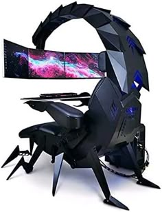 a computer monitor sitting on top of a spider like chair with two monitors behind it