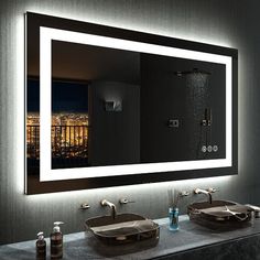 a bathroom with two sinks and a large mirror above it's counter top area