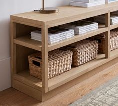 a wooden shelf with baskets and books on it