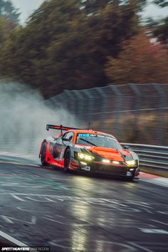 a car driving on a race track in the rain