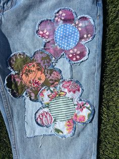 a pair of jeans with patchwork flowers on them