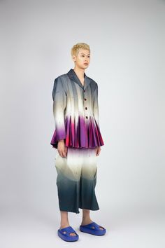 GENDER NEUTRAL Introducing the " DAWN PLEATS JACKET " jacket, a truly one-of-a-kind masterpiece that will elevate your style to new heights. This show-stopping piece features a mesmerising colour gradient print that captures the ethereal hues of dawn breaking over the horizon.The jacket's silhouette is inspired by the intricate, layered petals of the morning glory flower. Its all-around pleat design adds volume, texture, and movement to the garment. The pleats are carefully crafted to create a sense of fluidity as if the jacket is unfolding like a flower in bloom.The fit is bold and playful, with a slightly oversized silhouette that pairs perfectly with the matching print trousers.Every detail of the " DAWN PLEATS JACKET " jacket has been carefully considered to create a truly show-stoppin Avant-garde Long Sleeve Blazer For Spring, Tailored Long Sleeve Avant-garde Outerwear, Avant-garde Tailored Long Sleeve Outerwear, Tailored Avant-garde Long Sleeve Outerwear, Avant-garde Tailored Long Sleeve Blazer, Tailored Long Sleeve Avant-garde Blazer, Colour Gradient, Gradient Print, Pleated Jacket