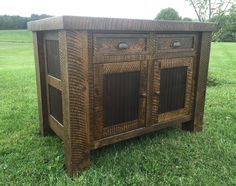 an old wooden cabinet sitting in the grass