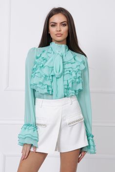 "This is the perfect shirt to add to your wardrobe! It's a versatile piece that can be dressed up or down. The mock-neck and ruffles give it a touch of elegance, while the mint color is unique and eye-catching. The shirt is also extremely comfortable and sheer, making it a great option for layering. Add this shirt to your wardrobe and enjoy the endless possibilities! MODEL INFO: Our model is 5'8 (173 cm.) and wearing size S. SIZES: XS, S, M, L, XL and Custom Size (Please, check the measurements Chic Long Sleeve Shirt For Spring, Chic Green Shirt For Daywear, Trendy Ruffled Collar Tops For Party, Spring Party Collared Shirt, Spring Party Shirt With Ruffles, Spring Party Shirt With Collar, Chic Long Sleeve Ruffled Shirt, Spring Green Ruffled Shirt, Green Ruffled Top For Office