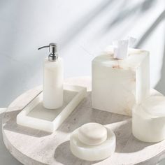 a bathroom set consisting of soap dispenser, soap dish and toilet paper holder