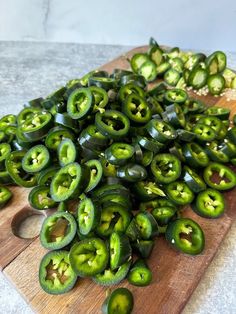 green peppers are on a cutting board and ready to be cooked