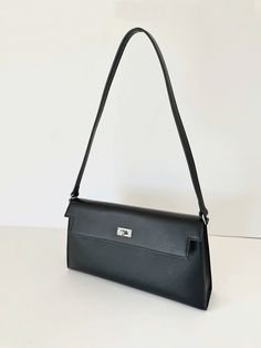 A classic day-and-night favorite from FREYA ESTEPHAN. Pochette shoulder bag  * 100% genuine leather   * 27.5cm wide x 6cm deep x 15cm high   * Silver hardware. Buckle closure  * 42cm height including shoulder strap  * Colour: black NEW, with tags Classic Shoulder Baguette Bag For Daily Use, Classic Baguette Shoulder Bag For Daily Use, Classic Office Baguette Shoulder Bag, Classic Shoulder Baguette Bag, Classic Baguette Shoulder Bag, Classic Crossbody Baguette Bag For Daily Use, Textured Leather Rectangular Baguette Bag For Travel, Classic Everyday Shoulder Flap Bag, Classic Business Flap Bag In Textured Leather