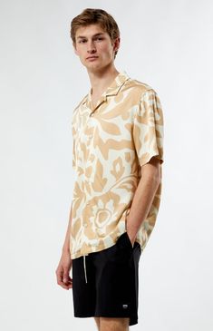 PacSun's Mari Tan Camp Shirt is a your go-to for laid-back sophistication. With its collared neckline, short sleeves, and regular fit, this shirt offers a timeless silhouette. Complete with button closures and a lightweight feel, its print throughout adds a touch of intrigue to your casual ensemble.


	Collared neckline
	Short sleeves
	Standard fit
	Button closures
	Custom pattern
	100% Rayon
	Machine washable
	Model is wearing size medium
	Model Measurements: 6'1.5” Height, 28” Waist, 32” Inseam Camp Shirt, Camping Shirt, Shirt Price, Exclusive Collection, Model Measurements, Pacsun, Cool Style, Top Shirt, Short Sleeves