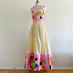 Vintage 1970s maxi dress by Georgia Charuhas, Boutique Las Marioposas, Merida Yucatan Mexico! A gorgeous collectible piece with a patchwork bodice trimmed in lace and a pale yellow pin tucked skirt edged with a deep band of quilted patchwork. The border has  padding for extra volume. Halter tie straps; back zip. 100% cotton. In very good condition, very clean and strong. Dress has one stain as shown on the skirt hem area; there are loose threads and some minor fraying to a few of the patchwork p Retro Cotton Maxi Dress, Vintage Multicolor Patchwork Dresses, 70s Mode, Merida Yucatan Mexico, Patchwork Dresses, Outstanding Outfits, Merida Yucatan, Quilt Dress, Quilted Patchwork