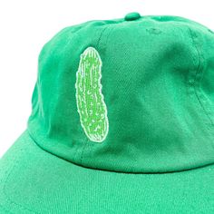 Our pickle hat is a very big dill! Meet your new go-to accessory: our unstructured cap with a quirky embroidered pickle! Featuring an antiqued brass side buckle for a relaxed, casual look, this hat adds a fun twist to any outfit. Ideal for those who love unique and playful fashion, it’s one size fits most, so everyone can enjoy the style! Green One Size Fits Most 5-panel Dad Hat, Green Cotton Dad Hat With Flat Brim, Green Cotton Flat Brim Dad Hat, Pickle Accessories, Playful Fashion, Big Dill, Clothing Optional, Embroidered Hat, Cotton Chinos